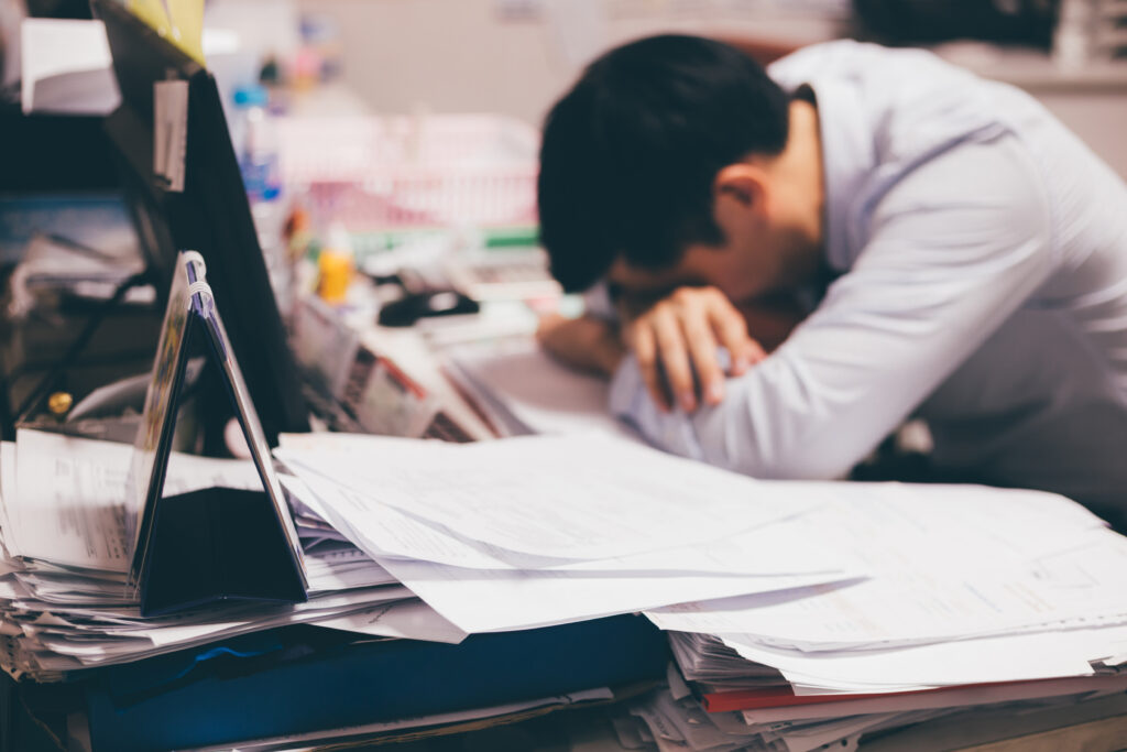 Man overwhelmed by spreadsheets